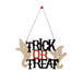 Halloween hanging wall sign reading 'TRICK OR TREAT' in black and orange lettering, with two beige ghost cutouts on either side, suspended by a black string from a small red top.