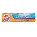 A tube of Arm & Hammer Advanced White toothpaste with packaging that highlights its whitening effect and flossing capabilities.