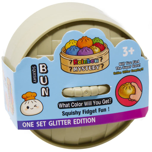 A packaged children's squishy fidget toy set labeled 'Rainbow Mystery Color Gainer Squiggle!' in a round beige plastic container with a blue and purple cardboard sleeve. The packaging includes cartoon chef illustrations, a cutout showing part of the beige fidget, and text noting 'One Set Glitter Edition' and '3+'.