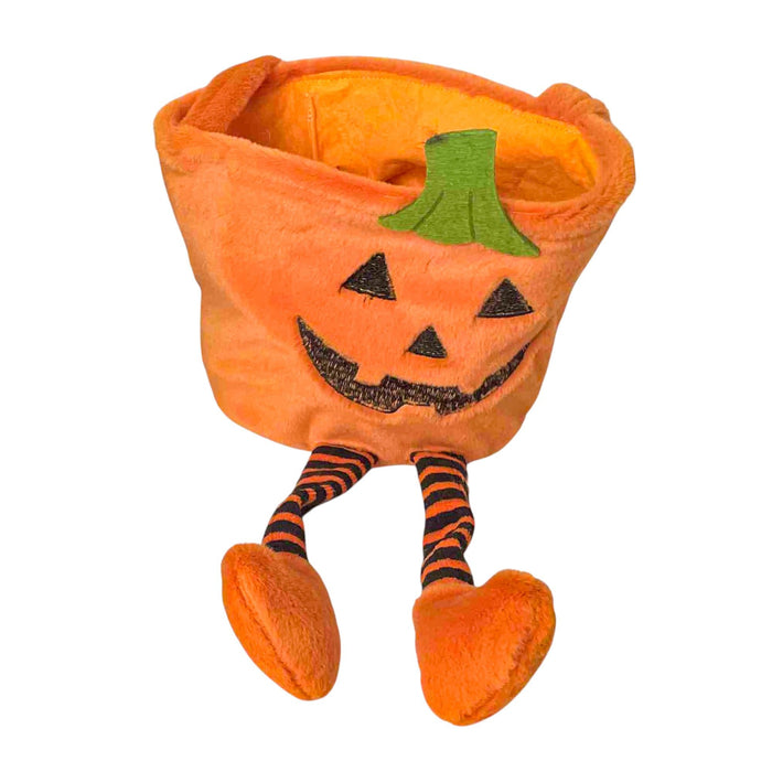 An orange plush pumpkin-shaped bucket with a stitched jack-o'-lantern face, green stem detail, and striped legs with orange foot-shaped hands, shown on a plain white background.