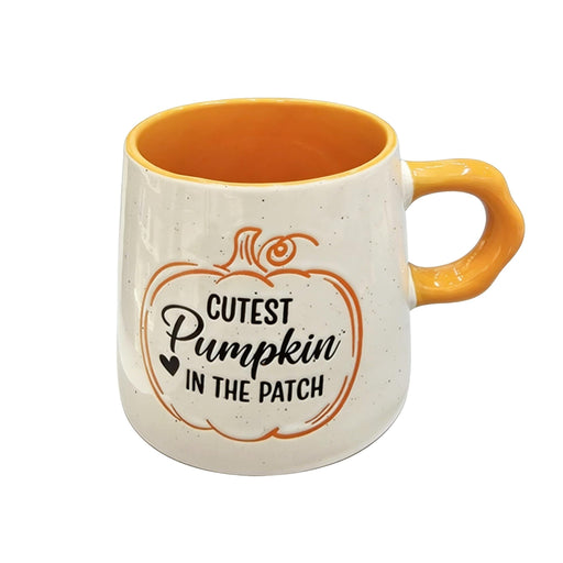 A ceramic mug with a speckled off-white exterior, a bright orange interior and handle, and a printed pumpkin graphic with the text 'Cutest Pumpkin in the Patch'.