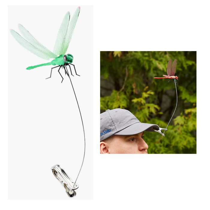 Dragonfly-shaped fishing lure with a man wearing a cap outdoors.