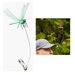 Dragonfly-shaped fishing lure with a man wearing a cap outdoors.