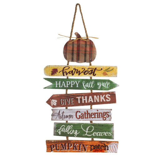 A rustic autumn-themed wooden sign hanging from a rope, featuring multiple horizontal planks with fall phrases like 'Harvest', 'HAPPY fall y'all', 'GIVE THANKS', 'Autumn Gatherings', 'falling Leaves', and 'PUMPKIN patch'. A plaid pumpkin decoration hangs from the top against a plain white background.
