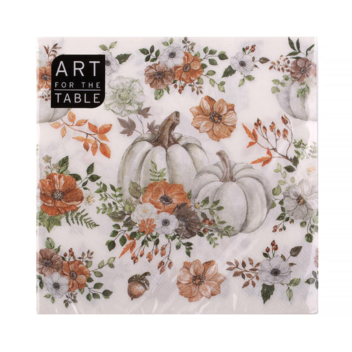 A square paper napkin with a fall harvest floral print, featuring watercolor-style pumpkins, orange and white flowers, and green leaves on a cream background. A black label in the top-left corner reads 'ART FOR THE TABLE'.