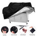 Black grill cover with handles, velcro straps, shrink rope, and storage bag on a white background