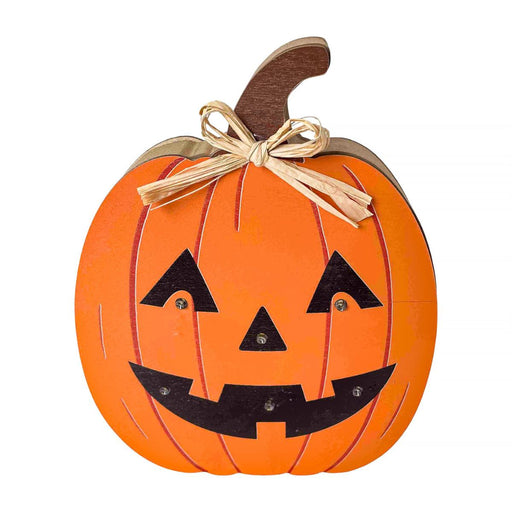A decorative jack-o'-lantern pumpkin wall hanging with a carved face, orange body, brown stem, and a beige twine bow, shown on a plain white background.