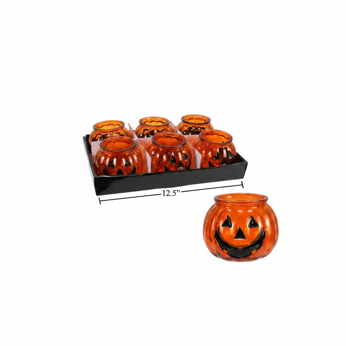 Six small orange pumpkin-shaped candle holders with black jack-o'-lantern faces, shown in a black tray with one held out. A dimension line indicates the tray is 12.