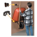 Person using a tool to open a door with a red wheelbarrow attached, against a plain background.