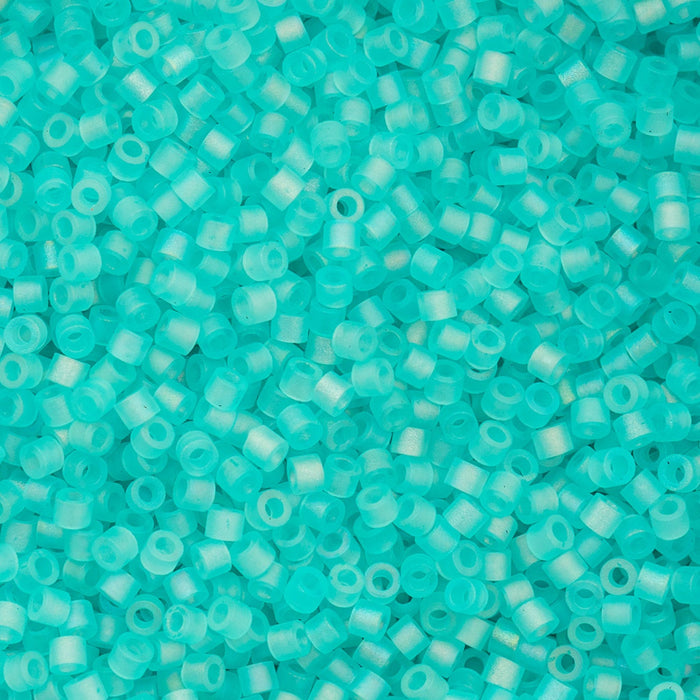 Turquoise glass beads of various sizes on a textured surface