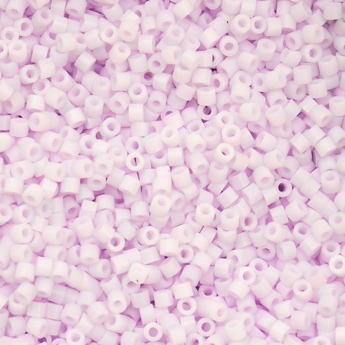 Close-up of small purple beads on a pink background