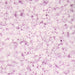 Close-up of small purple beads on a pink background