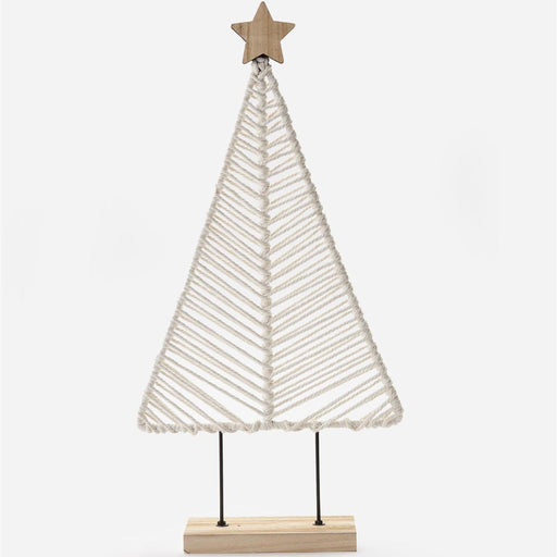 A minimalist macrame Christmas tree decoration made of off-white woven rope, mounted on a light wood base with two black metal stakes and topped with a wooden star, shown against a plain white background.