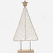 A minimalist macrame Christmas tree decoration made of off-white woven rope, mounted on a light wood base with two black metal stakes and topped with a wooden star, shown against a plain white background.