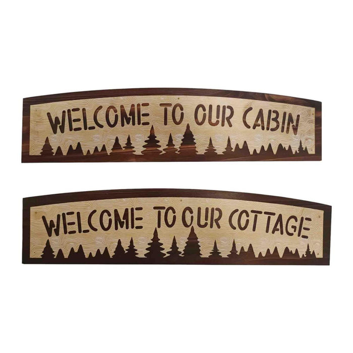 Two wooden signs with 'Welcome to our cabin' and 'Welcome to our cottage' text on a white background.