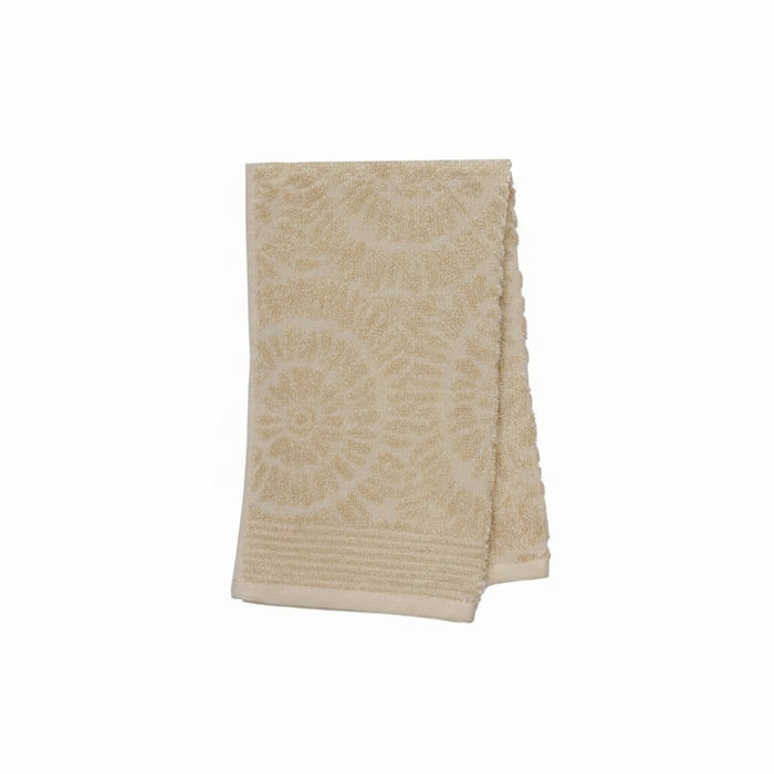 A folded beige bath towel with a textured, raised circular mandala pattern and a ribbed border, shown on a plain white background.