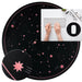 Round black mouse pad with pink star design, placed on a desk setup.