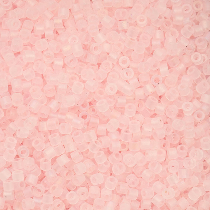 Close-up of light pink beads on a pink background