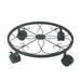 Decorative black metal plant stand with wheels on a white background