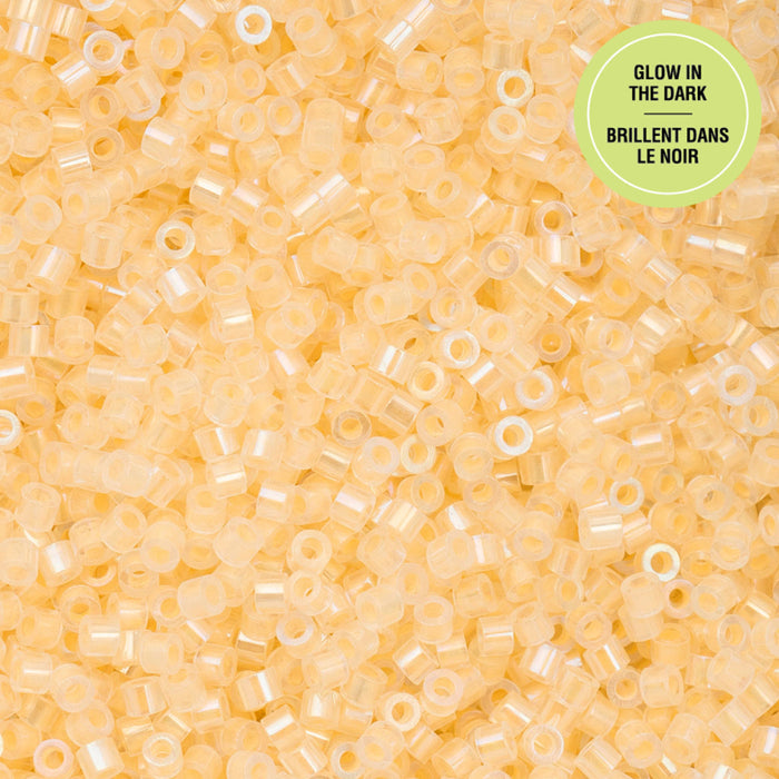 Close-up of small yellow beads with a green label on a yellow background