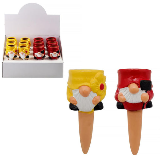 Two gnome-shaped planters, one yellow and one red, with a display box in the background.