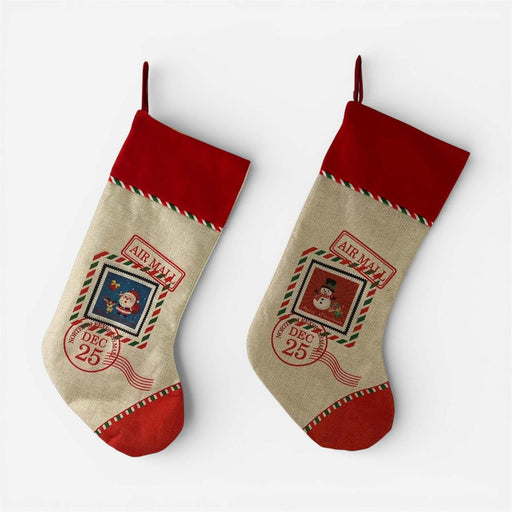Two Christmas stockings with red cuffs and heels, beige bodies, and red-and-green striped trim, each printed with holiday postmark graphics and the words 'Air Mail' and 'Dec. 25'.