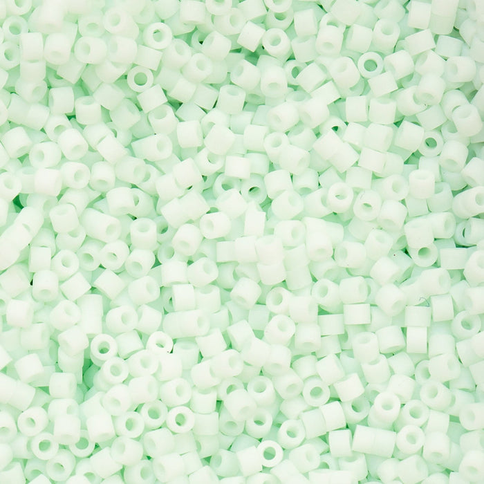 Close-up of light green plastic beads on a green background