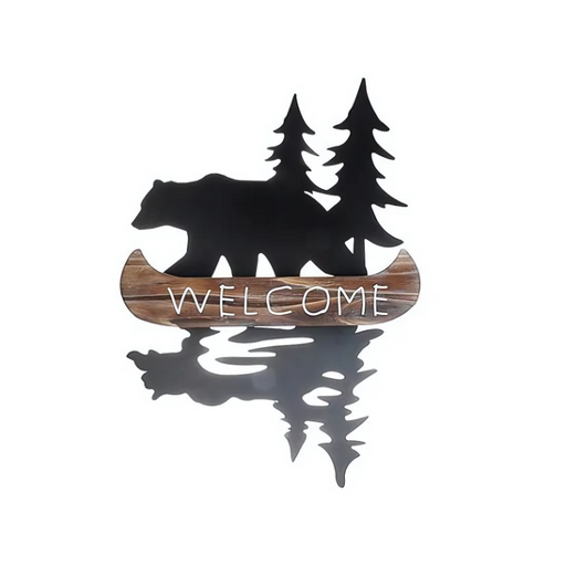 Rustic bear and pine tree silhouette metal wall décor with a faux wood canoe that says “WELCOME” in white lettering.