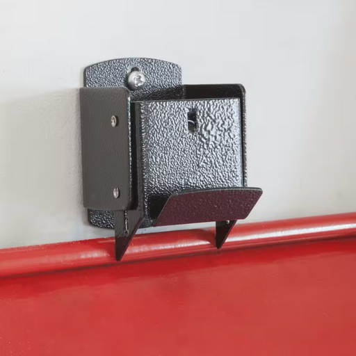 Metal bracket attached to a red surface with a white background