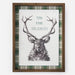 A framed holiday art print featuring a detailed black ink sketch of a stag with large antlers on a white textured background, surrounded by a green and white plaid border and a medium brown wooden frame.