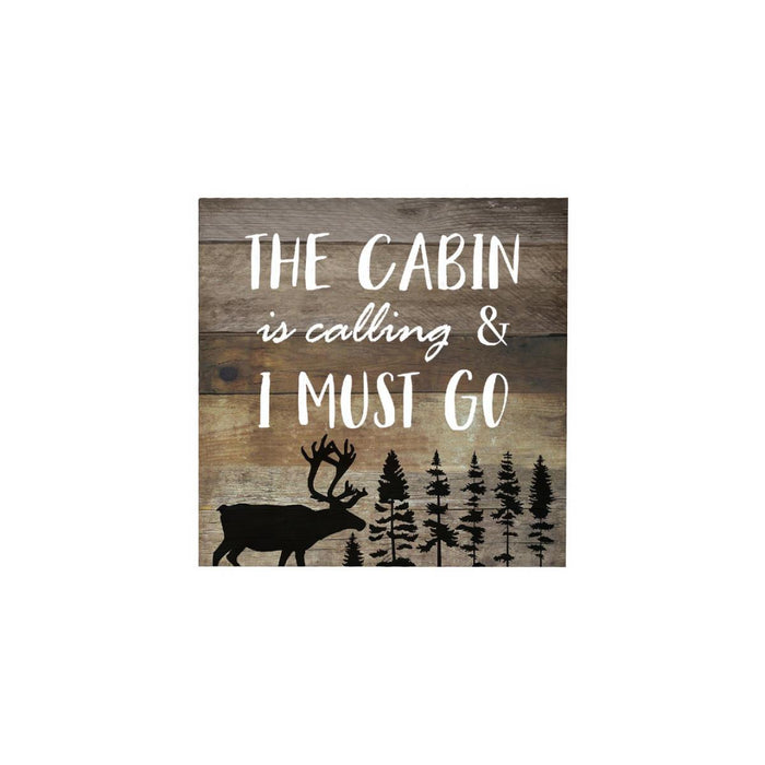 Wooden sign with text 'The cabin is calling & I must go' and a deer silhouette on a white background.