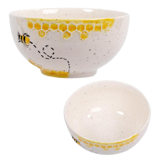 Two ceramic bowls with honeycomb and bee designs on a white background