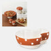 Ceramic bowl with polka dot design on a white background