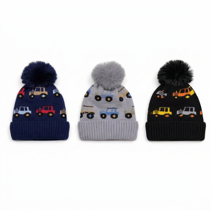 Three knit pom-pom beanies shown side by side on a white background: navy blue, light gray, and black, each with a different colored construction vehicle pattern.