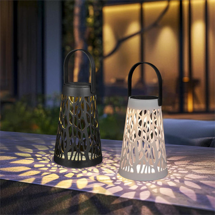 Two decorative lanterns casting shadows on a surface outdoors.