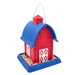 Red and blue birdhouse with a white door on a white background