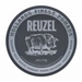 A round black and gray container of Reuzel pomade on a plain white background, featuring a pig illustration and the text 'Hollands Finest Pomade'.