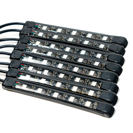 Six black LED light strips with attached black cables, arranged in a parallel stack on a white background.