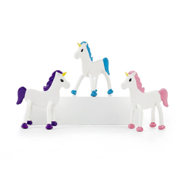 Three unicorn figurines with colorful manes and tails on a white background