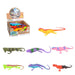 Colorful toy lizards displayed in front of a box with more toys inside.