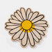 Daisy-shaped doormat with a yellow center and black outlines on a white background
