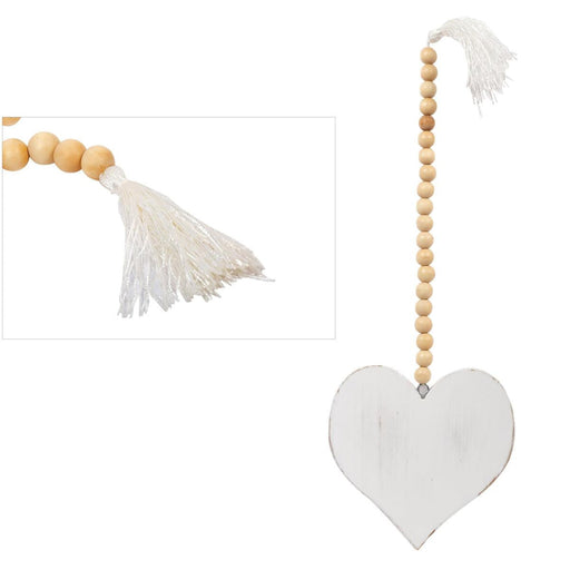 Decorative heart-shaped hanging with wooden beads and tassels on a white background