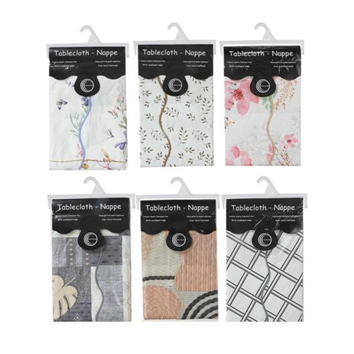 Packaging of tablecloths and napkins with floral, geometric, and abstract designs.