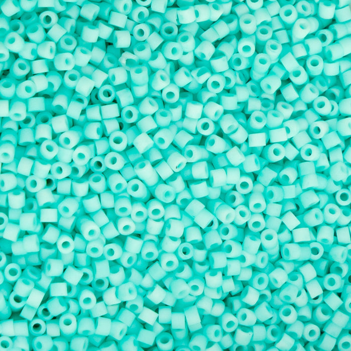 Turquoise glass beads on a turquoise background
