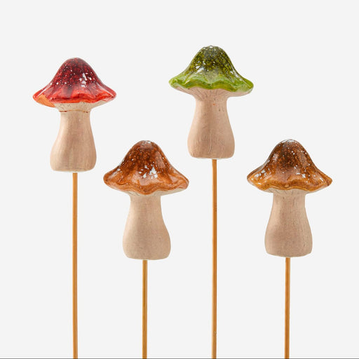 Five decorative mushroom sticks with different colored caps on a white background