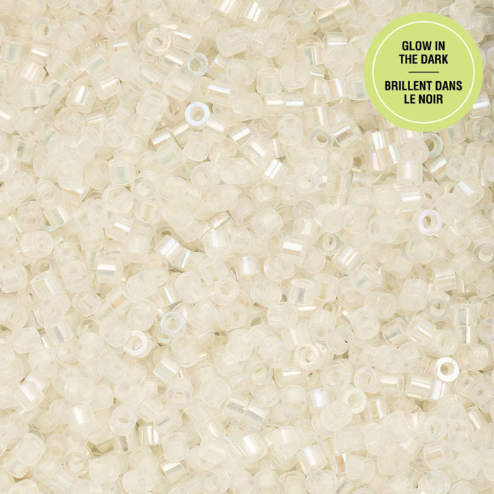 Close-up of small white beads with a green label indicating 'Glow in the Dark'.