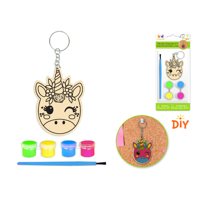 DIY unicorn-shaped wooden keychain craft kit with 4 neon paint colors and brush; includes photo of completed rainbow unicorn on corkboard.