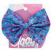 Blue splatter-print fabric bow barrette from Goody Kids, attached to pink packaging with “Stay Tight” technology label.