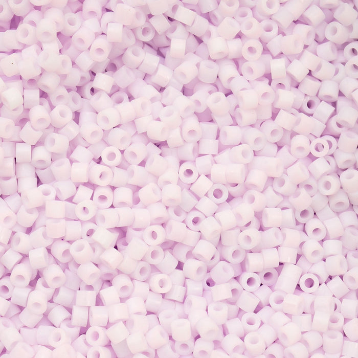 Close-up of light purple beads on a pink background