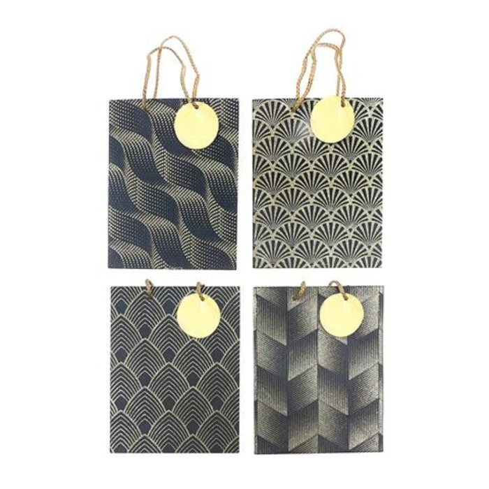Four gift bags arranged in a 2x2 grid on a white background, each with a different black and gold geometric pattern and a round gold tag attached by twine.